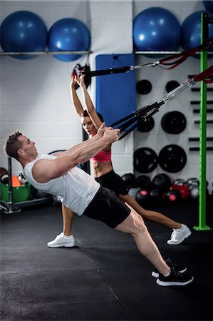 Man and woman doing suspension training with trx fitness straps Stock Photo - Premium Royalty-Free, Code: 6109-08537488