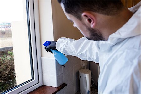 Man doing pest control in kitchen Photographie de stock - Premium Libres de Droits, Code: 6109-08537557