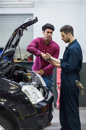 simsearch:6109-08537616,k - Customer shaking hands with mechanic Stock Photo - Premium Royalty-Free, Code: 6109-08537656