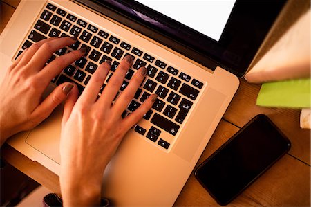 simsearch:6109-08537097,k - Womans hand using laptop Stock Photo - Premium Royalty-Free, Code: 6109-08537791
