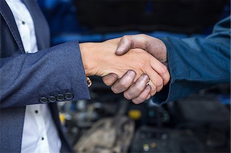 Customer shaking hands with mechanic Stock Photo - Premium Royalty-Free, Code: 6109-08537727