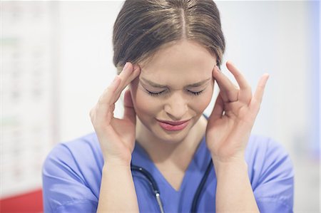 Stressed vet with hand on forehead Stock Photo - Premium Royalty-Free, Code: 6109-08537918