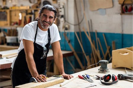 simsearch:6109-08537962,k - Happy carpenter standing in workshop Stock Photo - Premium Royalty-Free, Code: 6109-08538031