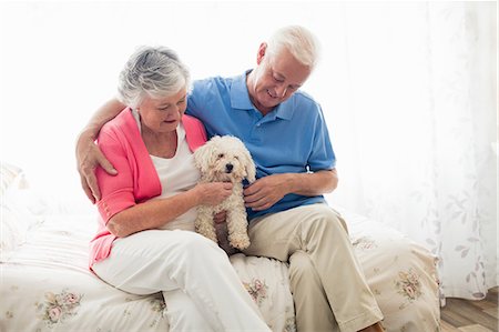 senior couple with pet - Senior couple holding a dog Stock Photo - Premium Royalty-Free, Code: 6109-08538267