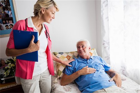 senior nursing home - Nurse taking care of a senior woman Stock Photo - Premium Royalty-Free, Code: 6109-08538281