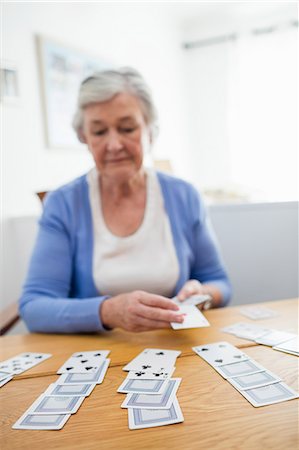 solitaire - Senior woman playing cards Stock Photo - Premium Royalty-Free, Code: 6109-08538225