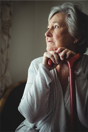 elderly woman nursing home - Thoughtful senior woman with cane Stock Photo - Premium Royalty-Free, Code: 6109-08538382