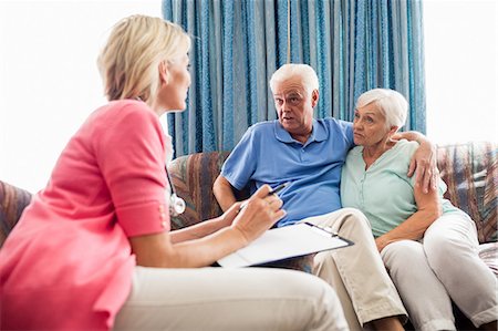 Nurse making a contract with a senior couple Stock Photo - Premium Royalty-Free, Code: 6109-08538302