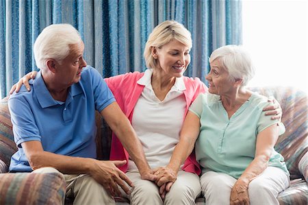 simsearch:6109-08538302,k - Nurse sitting between a senior couple Stock Photo - Premium Royalty-Free, Code: 6109-08538309