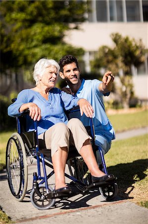 simsearch:6109-08538435,k - Nurse pushing the senior womans Zimmer frame Stock Photo - Premium Royalty-Free, Code: 6109-08538448