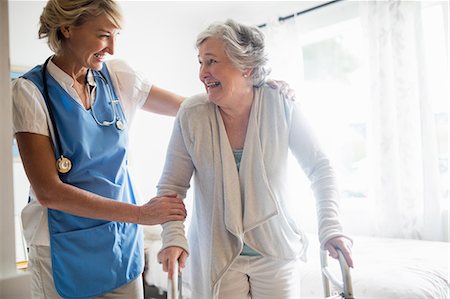 simsearch:6109-08538475,k - Nurse helping senior woman to stand up Stock Photo - Premium Royalty-Free, Code: 6109-08538474