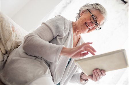 retirement concept - Senior woman looking at her tablet Stock Photo - Premium Royalty-Free, Code: 6109-08538502