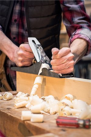 simsearch:6109-08689631,k - Portrait of carpenter perfecting wood plank form with a work tool in his workshop Photographie de stock - Premium Libres de Droits, Code: 6109-08689694