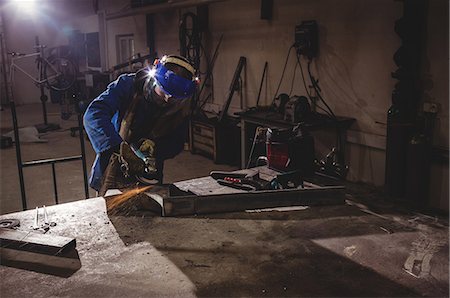 simsearch:6108-08636989,k - Welder cutting metal with grinder in workshop Stock Photo - Premium Royalty-Free, Code: 6109-08689632