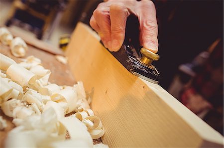 simsearch:400-05385082,k - Close-up of carpenter using a sander on a wood plank in his workshop Stock Photo - Premium Royalty-Free, Code: 6109-08689701