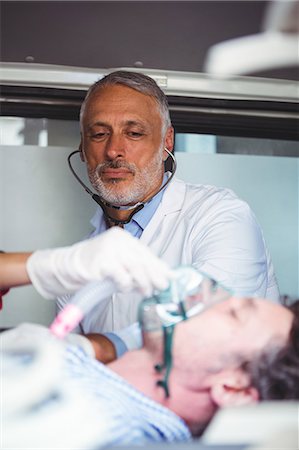 rushing with stretcher - Doctor taking care of an injured man Stock Photo - Premium Royalty-Free, Code: 6109-08689802