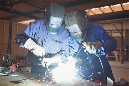 Welders welding a metal in workshop Stock Photo - Premium Royalty-Free, Code: 6109-08689824