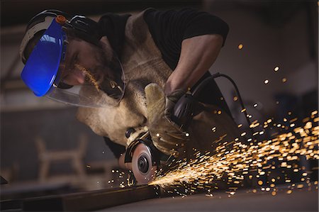 protective glove - Welder working with machine in the workshop Stock Photo - Premium Royalty-Free, Code: 6109-08689980