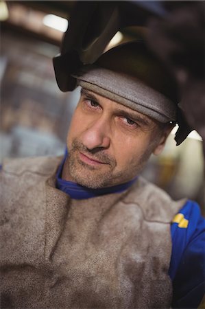 Welder looking at the camera in the workshop Stock Photo - Premium Royalty-Free, Code: 6109-08689982