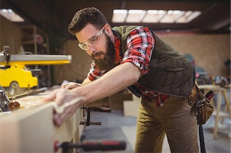 simsearch:6109-08537962,k - Carpenter measuring wooden plank in workshop Stock Photo - Premium Royalty-Free, Code: 6109-08689924