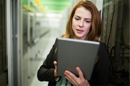 Technician using digital tablet in server room Stock Photo - Premium Royalty-Free, Code: 6109-08690087