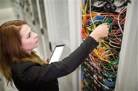 router - Technician holding digital tablet while examining server in server room Stock Photo - Premium Royalty-Free, Code: 6109-08690089