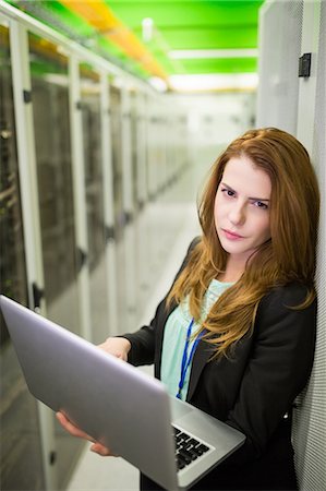 system - Portrait of technician using laptop in server room Stock Photo - Premium Royalty-Free, Code: 6109-08690095