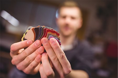 simsearch:700-02958016,k - Cobbler holding small pieces of material in workshop Stock Photo - Premium Royalty-Free, Code: 6109-08690026