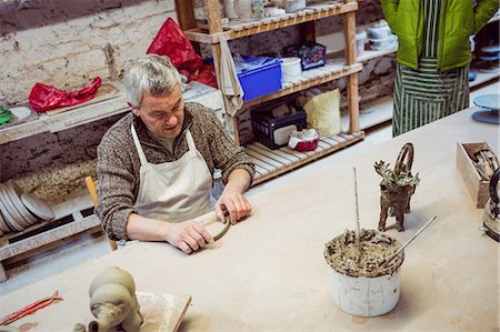 simsearch:6109-08705486,k - High angle view of male potter working at table in workshop Photographie de stock - Premium Libres de Droits, Code: 6109-08690163