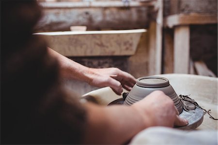 simsearch:649-07736605,k - Cropped image of craftsperson making ceramic container in workshop Photographie de stock - Premium Libres de Droits, Code: 6109-08690180