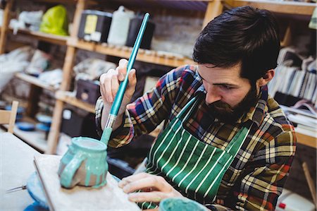 simsearch:6109-08705486,k - Focsed bearded man working at workshop Photographie de stock - Premium Libres de Droits, Code: 6109-08690195