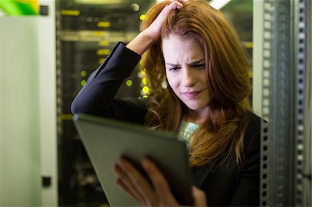 frustrated person and storage - Technician using digital tablet in server room Stock Photo - Premium Royalty-Free, Code: 6109-08690101