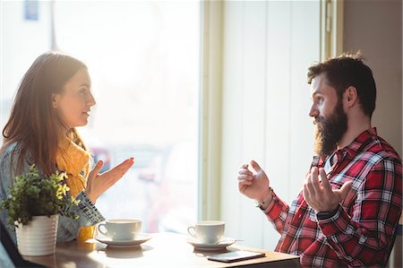 simsearch:6109-08690396,k - Young Man and woman talking at cafe Stock Photo - Premium Royalty-Free, Code: 6109-08690390