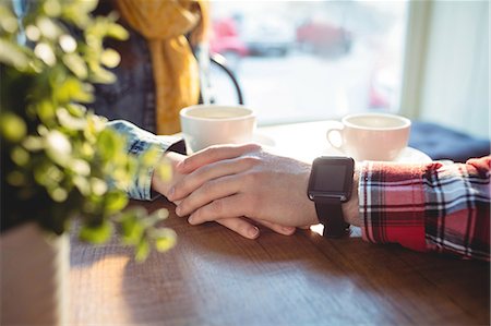 simsearch:6109-08690396,k - Close-up of couple holding hands on table at cafe Stock Photo - Premium Royalty-Free, Code: 6109-08690392