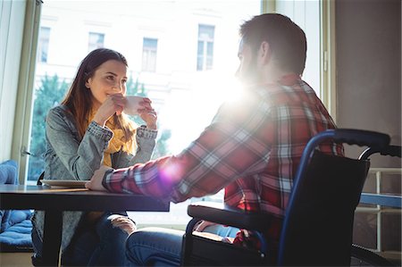 disabled men - Happy woman looking at disabled boyfriend at cafe Stock Photo - Premium Royalty-Free, Code: 6109-08690397