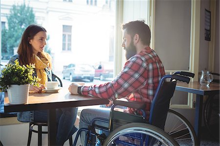 simsearch:6109-08690396,k - Disabled hipster with young woman at cafe Stock Photo - Premium Royalty-Free, Code: 6109-08690395