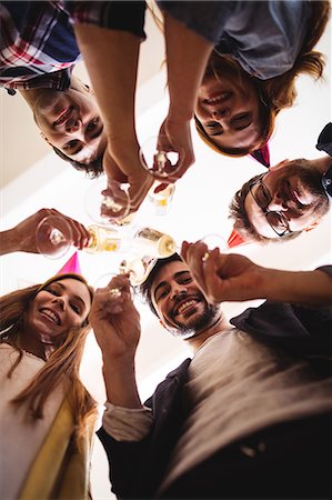 simsearch:6109-08690275,k - Portrait of smiling business people toasting drink at birthday party in creative office Photographie de stock - Premium Libres de Droits, Code: 6109-08690339