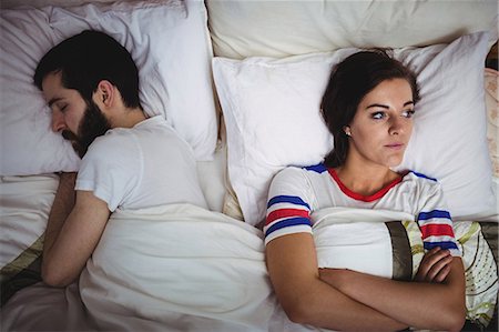 photo of sad man laying on pillow - Upset woman lying on bed at bedroom Stock Photo - Premium Royalty-Free, Code: 6109-08763894