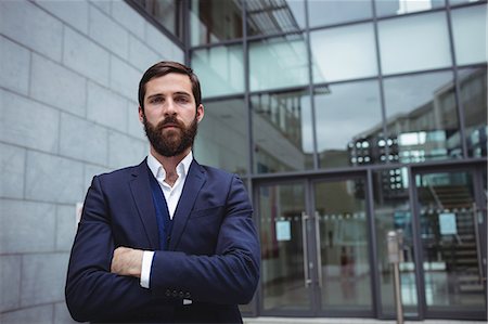 simsearch:6109-08763979,k - Portrait of businessman standing with arms crossed outside office Stock Photo - Premium Royalty-Free, Code: 6109-08763960