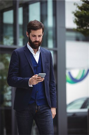 simsearch:6109-08829709,k - Businessman using mobile phone outside office Stock Photo - Premium Royalty-Free, Code: 6109-08763964