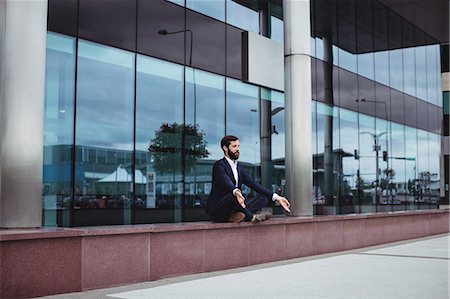 simsearch:622-08657638,k - Businessman practicing yoga outside office building Stock Photo - Premium Royalty-Free, Code: 6109-08763999