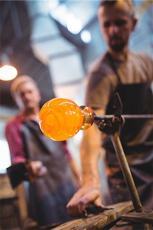 simsearch:6109-08764042,k - Glassblower shaping a molten glass at glassblowing factory Stock Photo - Premium Royalty-Free, Code: 6109-08764054
