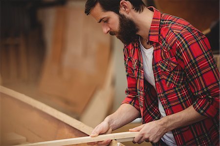 Man preparing wooden boat frame in boatyard Stock Photo - Premium Royalty-Free, Code: 6109-08764349