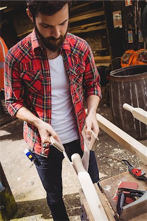 simsearch:6109-08764368,k - Man working on wooden plank in boatyard Stockbilder - Premium RF Lizenzfrei, Bildnummer: 6109-08764359