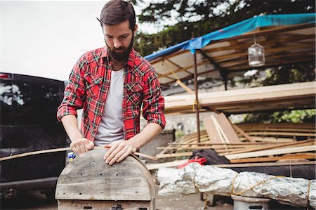 Man preparing a wooden boat frame at boatyard Stock Photo - Premium Royalty-Free, Code: 6109-08764393