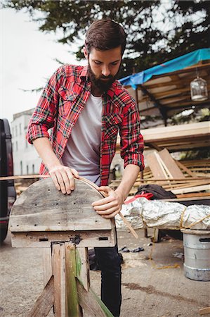 Man preparing a wooden boat frame at boatyard Stock Photo - Premium Royalty-Free, Code: 6109-08764394