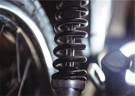 Close-up of motorbike shock absorber in workshop Stock Photo - Premium Royalty-Free, Code: 6109-08764453