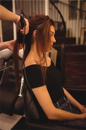 enderezando - Woman is getting her hair straightened at hair saloon Foto de stock - Sin royalties Premium, Código: 6109-08764646