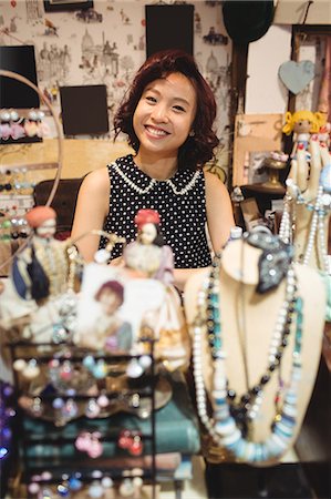 simsearch:6109-08952901,k - Portrait of smiling woman shopping for jeweler in a antique jeweler shops Stock Photo - Premium Royalty-Free, Code: 6109-08764614