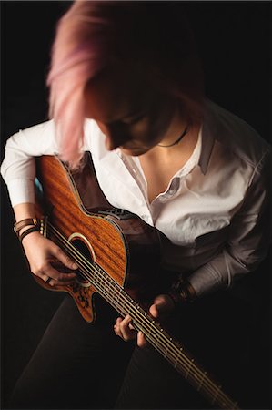 simsearch:6109-08764998,k - Woman playing a guitar in music school Stock Photo - Premium Royalty-Free, Code: 6109-08764718